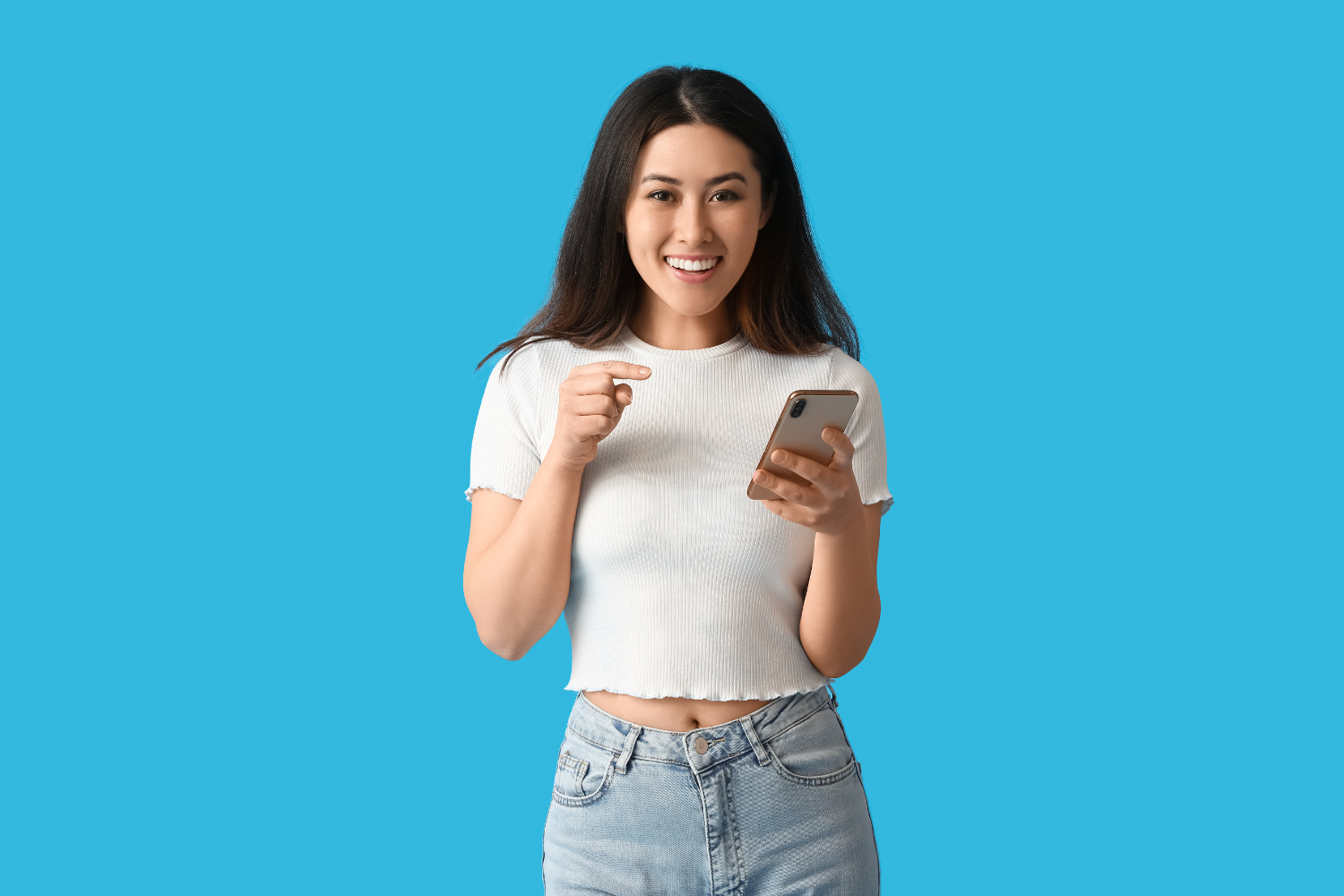 Young woman using mobile phone and smiling