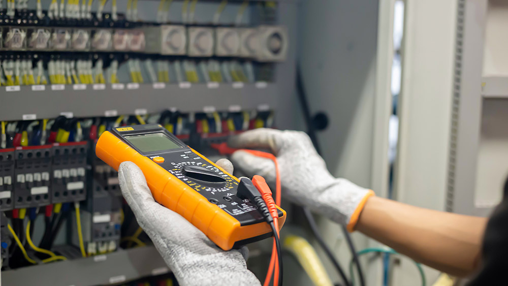 Electrician engineer uses a multimeter to test the electrical in Test and measurement