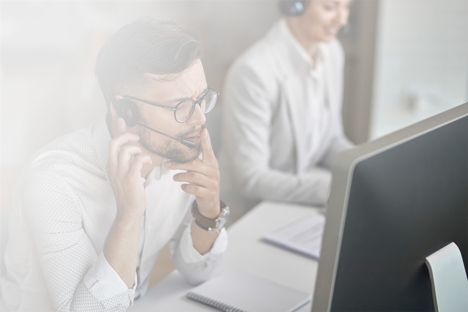 concentrated-call-center-agent-talking-with-customer-while-working-office_gradient_1500px call center agent talking with customer while working